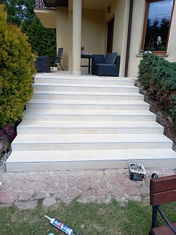 laying stone tiles with grouting and stairs