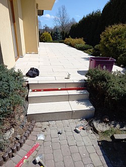 laying stone tiles with grouting and stairs